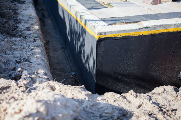 Professional Basement Waterproofing technician working in Fayetteville, AL